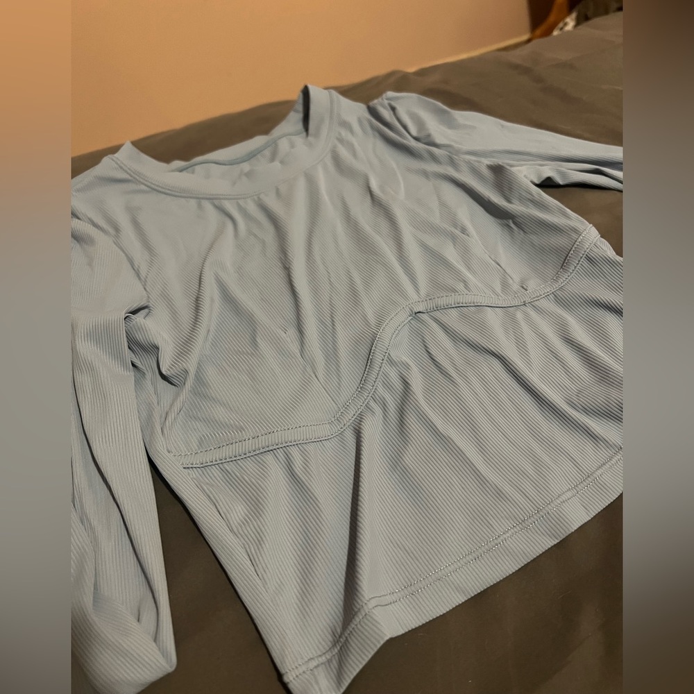 Light blue long sleeve. Says medium size 6 but fits xs/small. Never worn